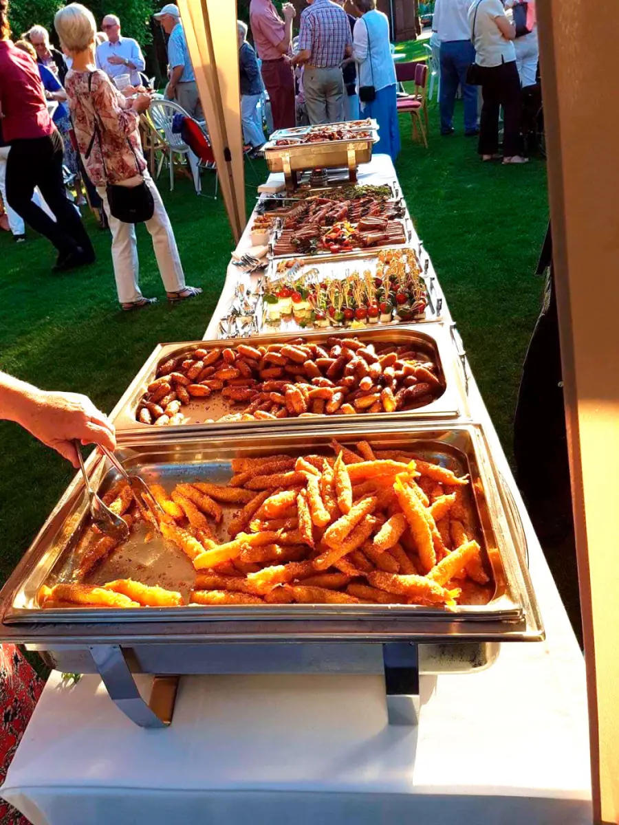 A garden-party buffet catered by Bernard Audemard, with chafing dishes of seasonal food